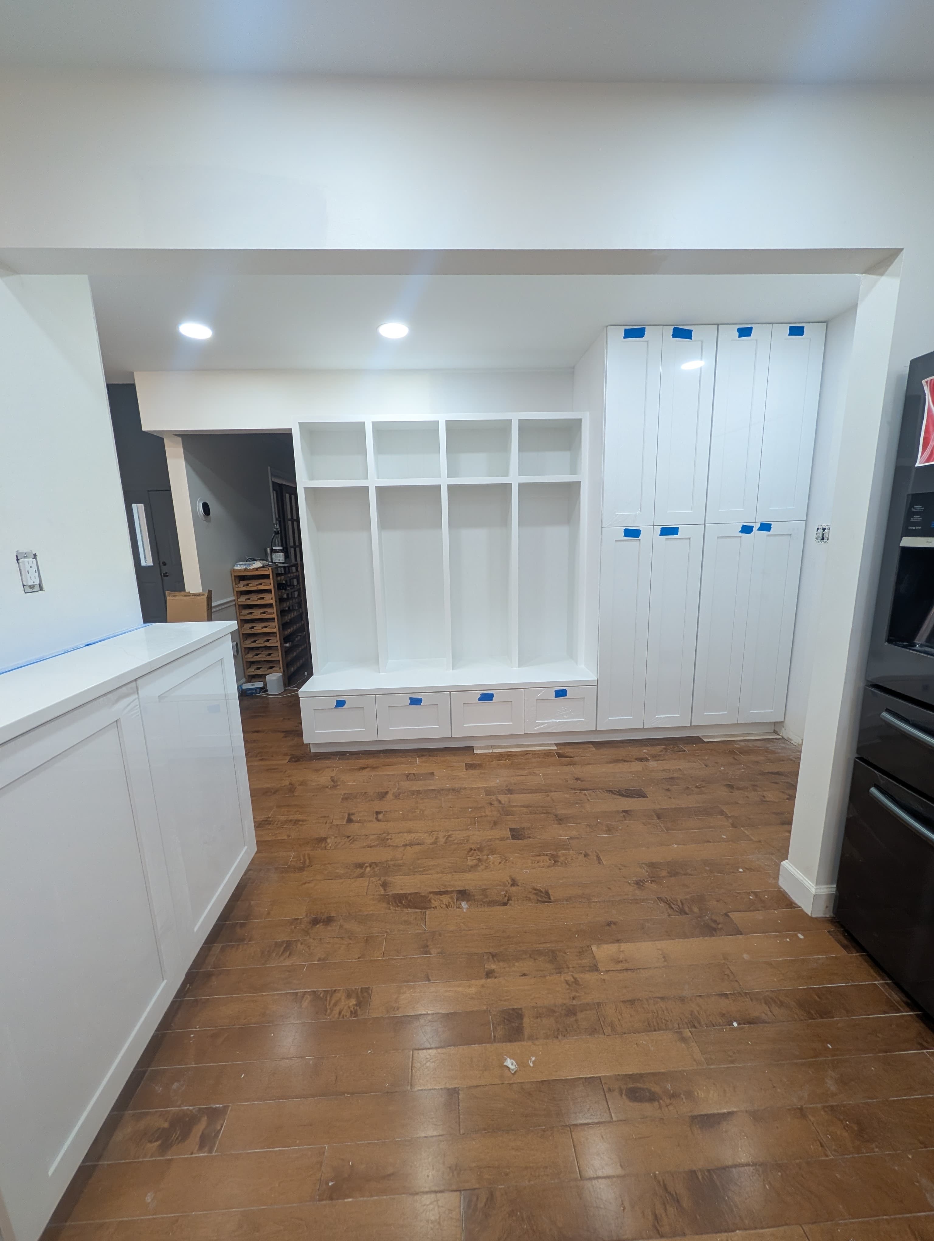 New Herndon kitchen in progress, wide view with a black french-door refrigerator and stacked wall ovens